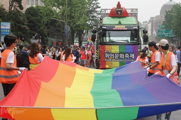 11일 퀴어문화축제 행진이 시작하는 모습. 축제 자원봉사자들이 무지개 천을 들고 행진했다.