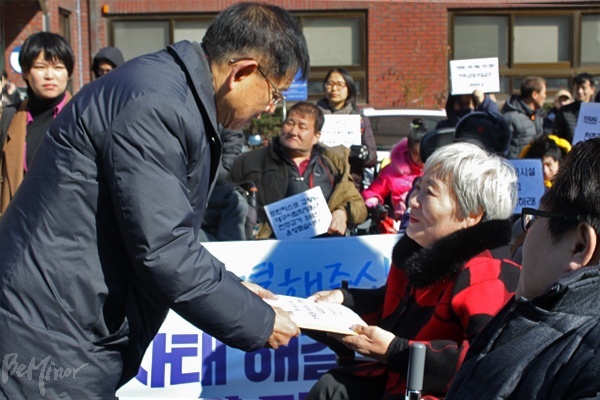 프란치스코 교황에게 '희망원 사태 근본적 해결'을 요청하는 서한을 주한 교황 대사관 직원에게 전달하고 있다.