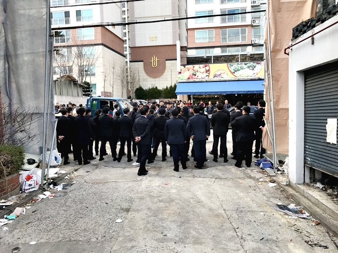 서울북부지방법원 집행관들이 장위7구역의 철거대상 주택 출입 통로를 가로막고 서 있다.