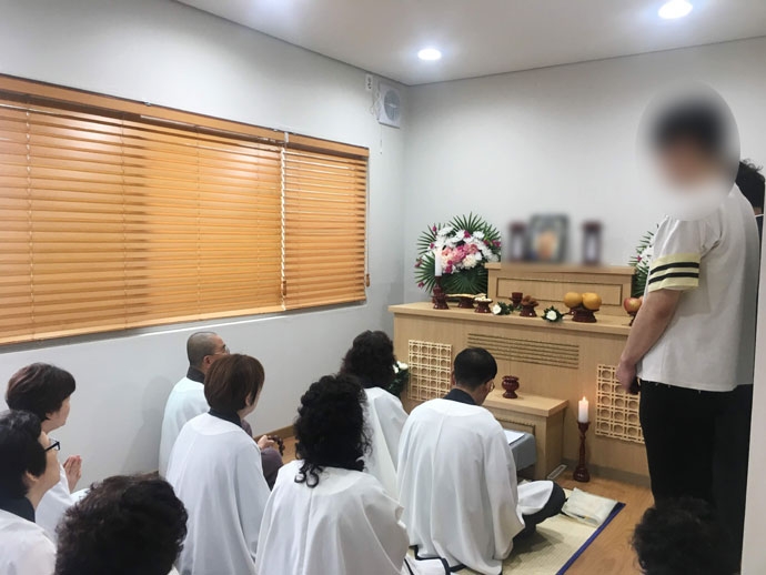 올해 7월, 중국 국적의 무연고 사망자 장례가 진행되고 있는 서울시립승화원 무연고자 전용 빈소. 형편이 어려워 시신을 위임했지만 아들이 참석해 종교의식을 함께하고 있습니다. ⓒ나눔과나눔