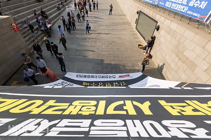 장애계가 장애등급제 ‘진짜’ 폐지를 위한 예산 확대를 요구하며 홍남기 기획재정부 장관을 ‘긴급 현상수배’하는 대형 현수막을 15일 세종문화회관 중앙 계단과 광화문 해치마당에 내걸었다. 사진 박승원