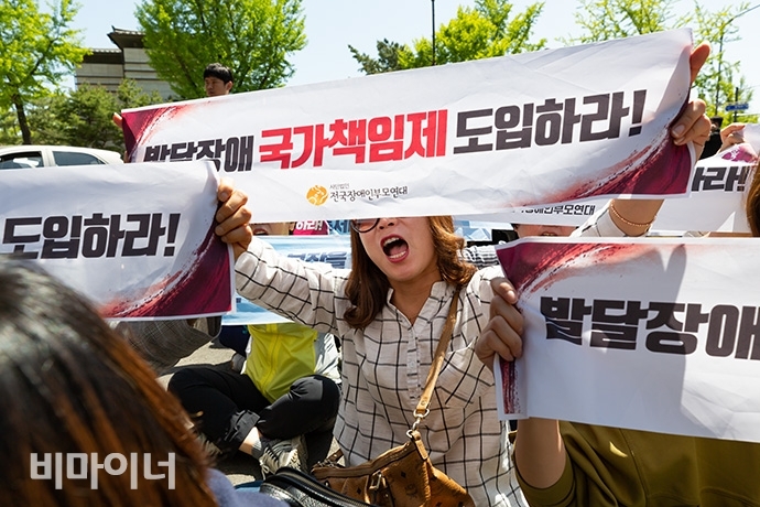 지난 5월, 전국장애인부모연대 회원들이 발달장애 국가책임제 도입을 촉구하며 청와대 춘추관 앞에서 문재인 대통령 면담을 촉구하는 기습시위를 벌였다. 사진 박승원