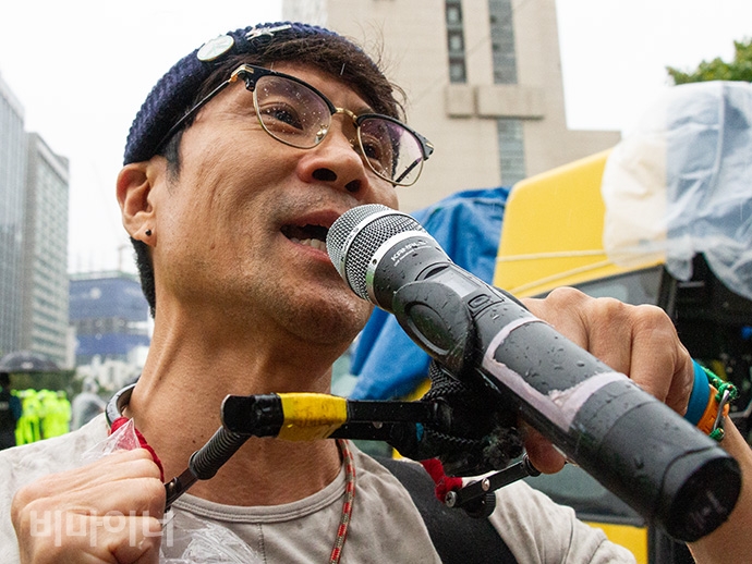 박준 노동가수가 서울시청으로 행진하는 장애계를 위해 노래로 연대했다. 사진 박승원