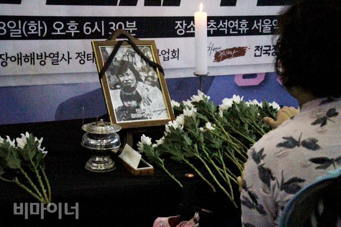 김순석 열사 기일을 하루 앞둔 2018년 9월 18일, 서울역에서 열린 김순석 열사 34주기 추모제. 과거 한 언론사에 실린 김순석 열사 흑백 사진이 영정 사진으로 놓여있으며 그 앞에 국화가 있다. 사진 최한별