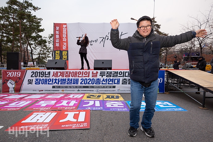 전국장애인차별철폐연대 등 500여 명의 장애인 활동가들은 세계장애인의 날인 3일 오후 3시 국회의사당역 2번 출구 앞에서 ‘2019년 세계장애인의 날 투쟁결의대회 및 장애인차별철폐 2020 총선연대 출범식’을 가졌다. 황기만 김포장애인야학센터 활동가가 임정득 노동가수가 부르는 노래에 맞춰 춤추고 있다. 사진 박승원 전국장애인차별철폐연대 등 500여 명의 장애인 활동가들은 세계장애인의 날인 3일 오후 3시 국회의사당역 2번 출구 앞에서 ‘2019년 세계장애인의 날 투쟁결의대회 및 장애인차별철폐 2020 총선연대 출범식’을 가졌다. 황기만 김포장애인야학센터 활동가가 임정득 노동가수가 부르는 노래에 맞춰 춤추고 있다. 사진 박승원
