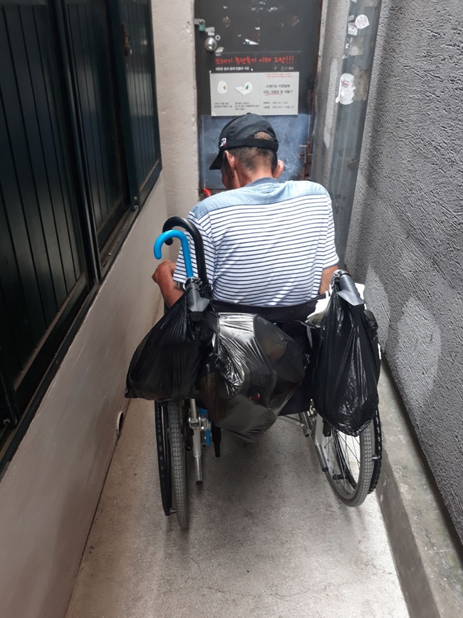 돈의동에서 그나마 문턱이 낮았던 쪽방 앞 골목. 휠체어를 돌릴 수도 없을 정도로 좁다. 휠체어를 대어놓으면 사람들이 지나다닐 수 없다. 사진 종교계노숙인지원민관협력네트워크