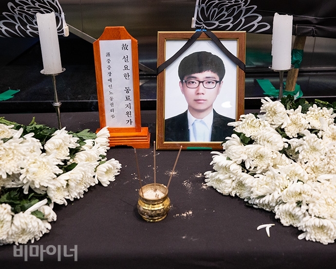 고용노동부가 시행하는 동료지원가 사업에 참여했던 고 설요한 씨는 과도한 업무와 실적 압박으로 지난 5일 스스로 목숨을 끊었다. 고인의 영정 앞에 국화가 놓여있다. 사진 박승원