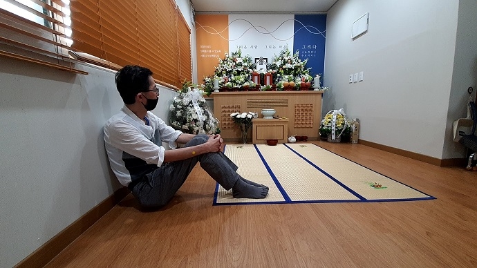 고아라는 인연으로 만난 친구를 무연고로 보내야 했던 친구가 영정을 바라보고 있다. 사진 나눔과나눔