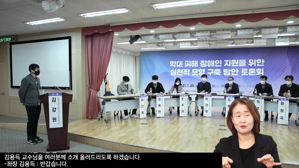 토론회 참여자들이 마스크를 착용하고 토론회장에 앉아있다. 토론회장 뒷면에는 '학대피해 장애인 지원을 위한 실천적 모형 구축방안 토론회'라고 적힌 큰 현수막이 걸려있다. 사진 함께걸음 유튜브 갈무리