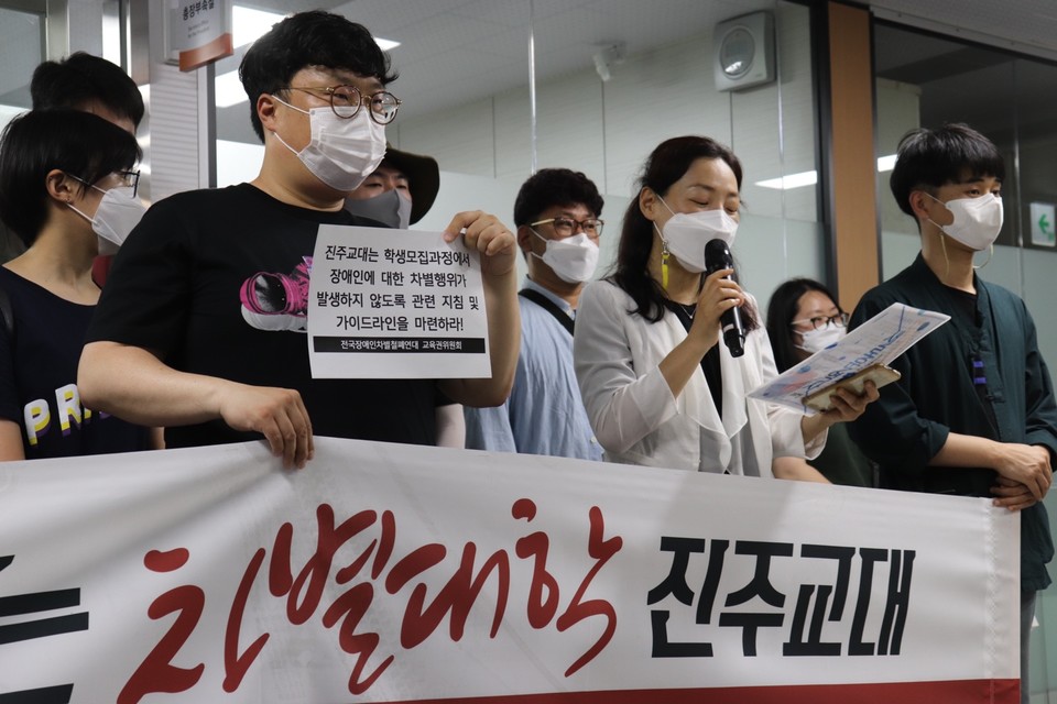 김수정 전교조 경남지부 참교육실장이 마이크를 잡고 발언하고 있다. 현수막에는 ‘차별대학 진주교대’라 적혀 있다. 사진 전장연