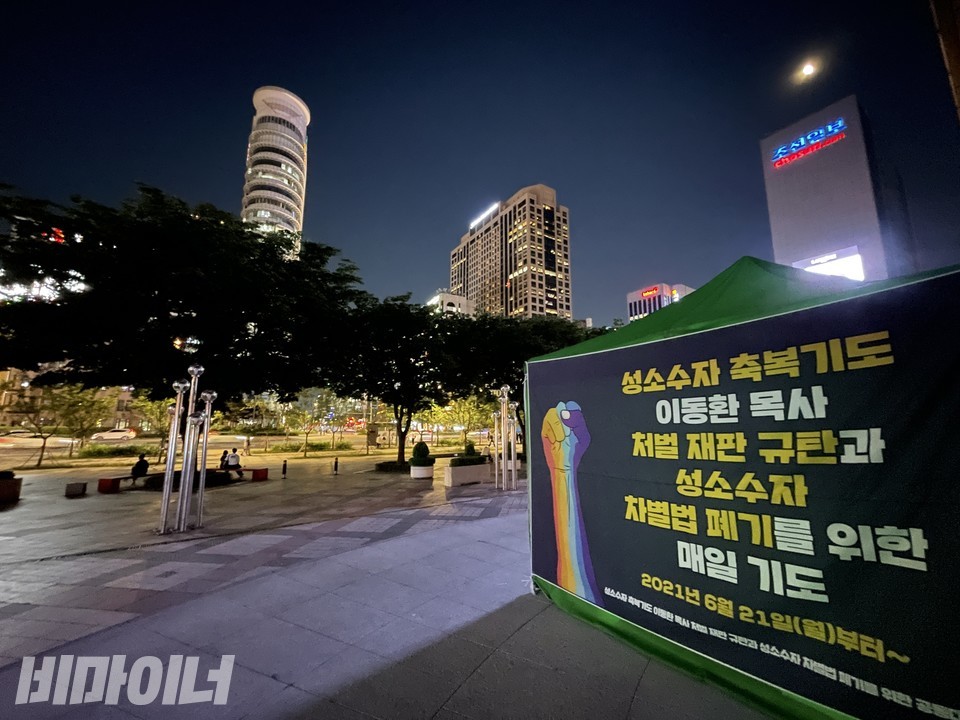 농성장 측면. 현수막에 ‘성소수자 축복기도 이동환 목사 처벌 재판 규탄과 성소수자 차별법 폐기를 위한 매일 기도’라고 젹혀 있다. 무지개색깔의 주먹 그림도 그려져 있다. 사진 하민지