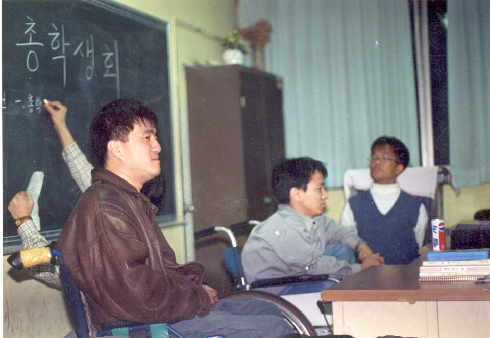 1996년 노들야학 총학생회에 참석한 박경석 대표. 갈색 가죽 자켓을 입고 있다. 사진 제공 노들야학 