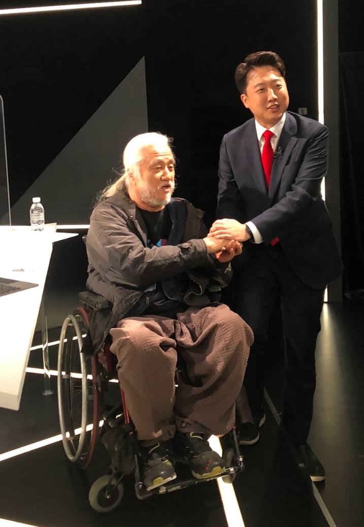 박경석 대표와 이준석 대표가 두 손을 맞잡고 인사하고 있다. 좁은 공간으로 인해 이준석 대표의 왼발은 무대 아래 내려와 있다. 즉, 비교적 크기가 작은 수동휠체어가 움직일 수 있는 여유 공간이 성인 남성 한 발 크기 정도에 불과했다. 사진 정창조