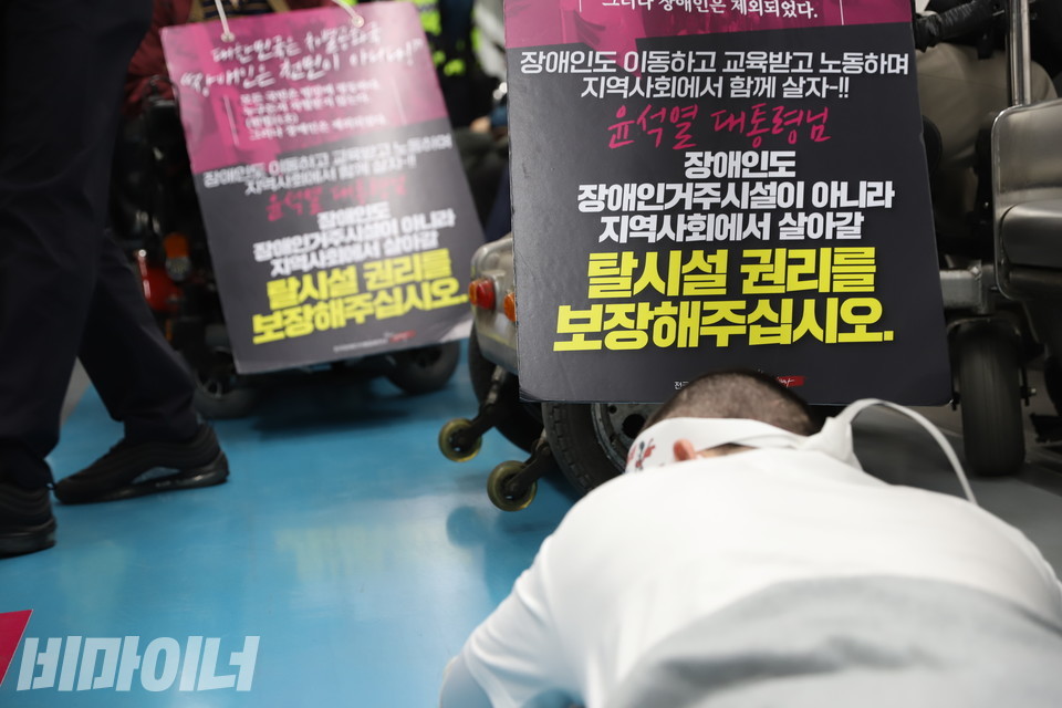 오체투지를 하는 이상도 활동가. 그의 앞에 “윤석열 대통령님, 장애인도 장애인거주시설이 아니라 지역사회에서 살아갈 탈시설 권리를 보장해주십시오”라고 적힌 피켓들이 있다. 사진 강혜민
