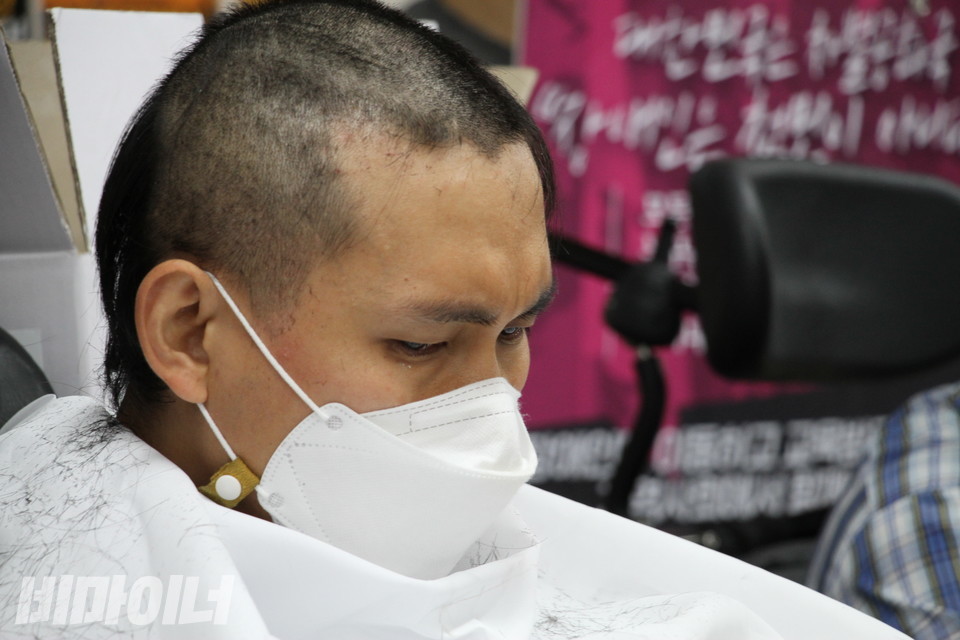 김민석 진주장애인자립생활센터 소장이 삭발하고 있다. 굳은 표정이다. 사진 허현덕