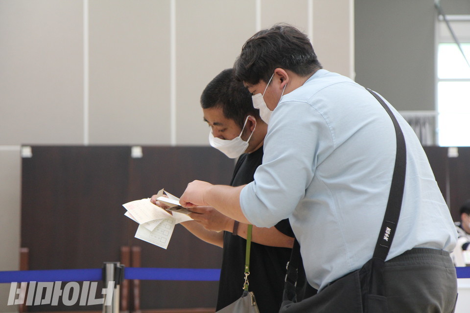 기표소에 들어가기 전, 임성재 씨가 투표보조인과 함께 투표용지를 살펴보고 있다. 사진 이슬하 