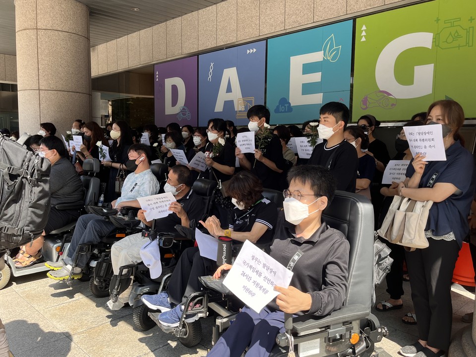 기자회견에 참여한 사람들의 모습. 손에는 요구안이 적힌 A4용지를 들고 있고 가슴 왼편에는 ‘근조(謹弔)’라고 적힌 까만 리본을 달았다. 사진 대구장차연 