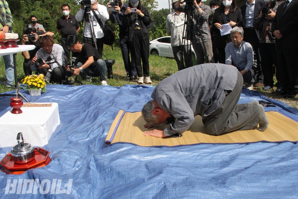 김훈 작가가 야산에 암매장된 선감학원 피해자들을 향해 절하고 있다. 사진 하민지