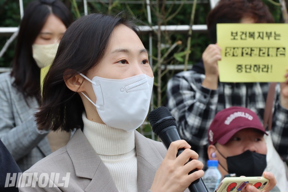 정다혜 변호사가 발언하고 있다. 정 변호사 뒤에 ‘보건복지부는 장애인권리 훼손 중단하라’라고 적힌 피켓이 보인다. 사진 하민지