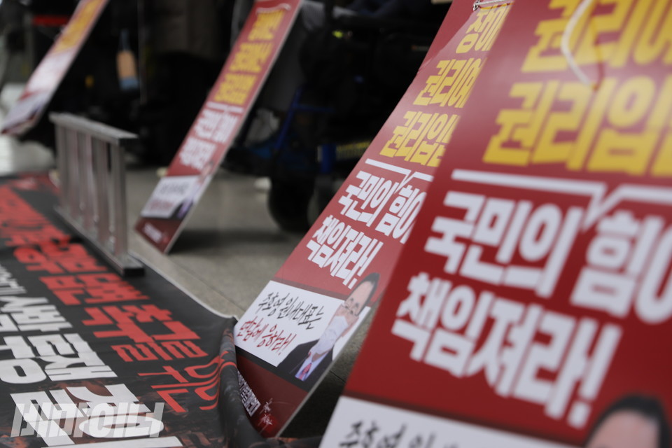 장애인권리예산 보장을 촉구하는 현수막 위로 피켓들이 일렬로 늘어서 있다. 사진 복건우