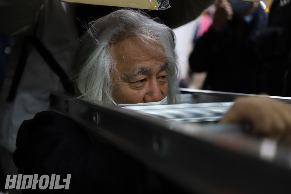 박경석 전장연 상임공동대표는 이날 사다리를 목에 걸고 승강장과 지하철 사이 출입문에서 선전전을 진행했다. 사진 복건우