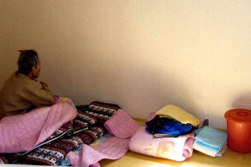 2005년 강원도 인제의 미신고시설 심신수양원에 수용된 할머니. 방은 밖에서 자물쇠로 잠겨 있었다. 빨간 통은 변기이며 방 안 가득 악취가 났다. 이후 심신수양원은 폐쇄됐다. 사진 전진호