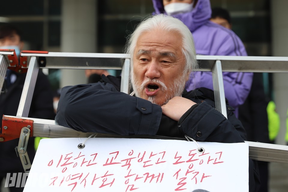 사다리를 목에 걸고 발언하는 박경석 전장연 상임공동대표. 사진 하민지