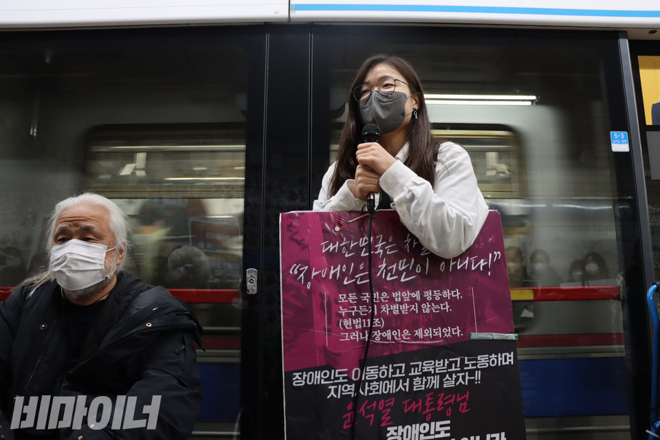선전전에 참여한 대학생 장세현 씨(오른쪽)가 목에 피켓을 걸고 발언하고 있다. 사진 복건우