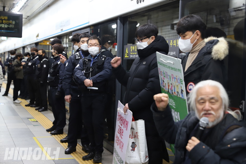 구호를 외치는 사람들. 이들 곁으로 서울교통공사 지하철 보안관들이 일렬로 서 있다. 사진 강혜민