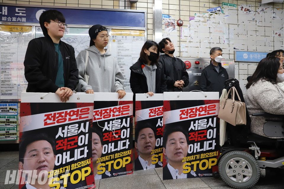 30일 오전 서울지하철 4호선 혜화역 선전전에 참여한 사람들이 ‘전장연은 서울시 적군이 아니다’라고 적힌 피켓을 들어 보이고 있다. 사진 복건우
