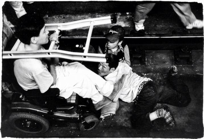 2002년 9월 11일, 2호선 시청역 선로를 점거한 장애인. 이규식이 선로 바닥을 기어가고 있다. 사진 장애인이동권연대 