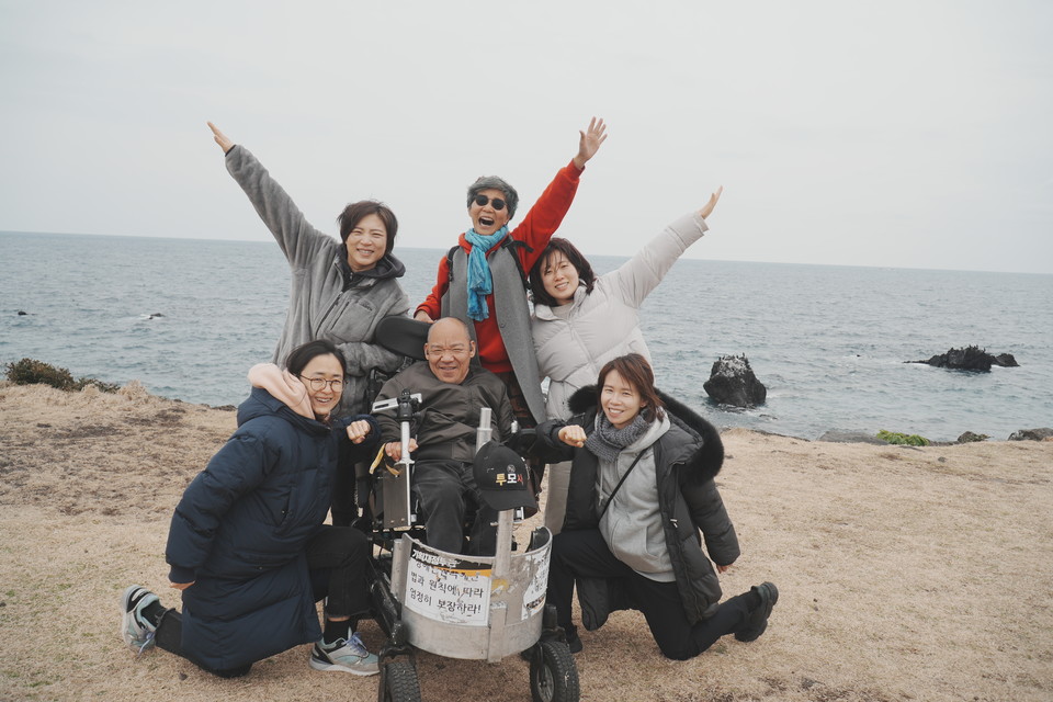 2023년 4월 14일, 박옥순 환갑잔치에 참여하기 위해 제주도 삼달다방에 장애와인권발바닥행동 활동가들이 모였다. 이규식이 바다목장에서 발바닥행동 활동가들과 환하게 웃고 있다. 사진 전진호 