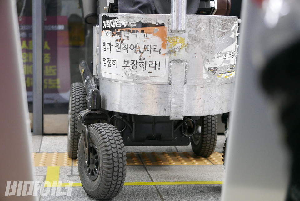 이규식의 휠체어. “장애인권리예산, 법과 원칙에 따라 엄정히 보장하라”는 스티커가 여기저기 찢기고 헤진 채 붙어있다. 사진 양유진