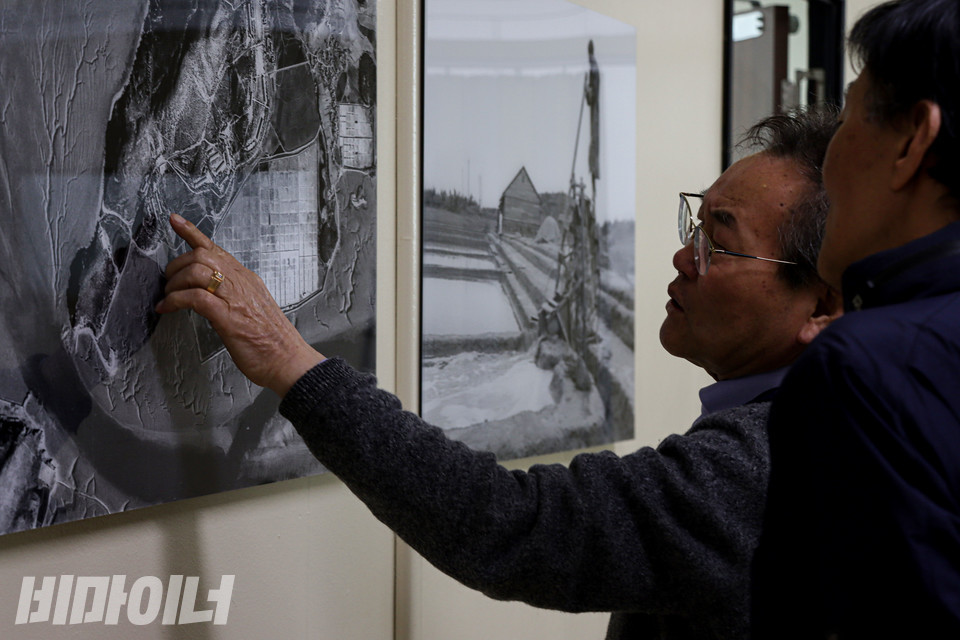 지난 4월 27일 경기도청 구청사에 있는 선감학원사건피해자지원센터에서 김영배 씨가 선감학원이 있던 경기도 안산시 선감도의 조감도를 손가락으로 짚으며 손석주 씨에게 당시 상황을 설명하고 있다. 사진 복건우