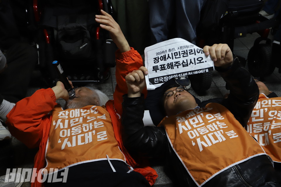 출근길 지하철행동 참여자들이 '비장애인 중심 사회를 멈춘다'는 의미를 담아 승강장 바닥에 드러눕는 '다이-인(die-in) 퍼포먼스'를 벌이고 있다. 사진 강혜민