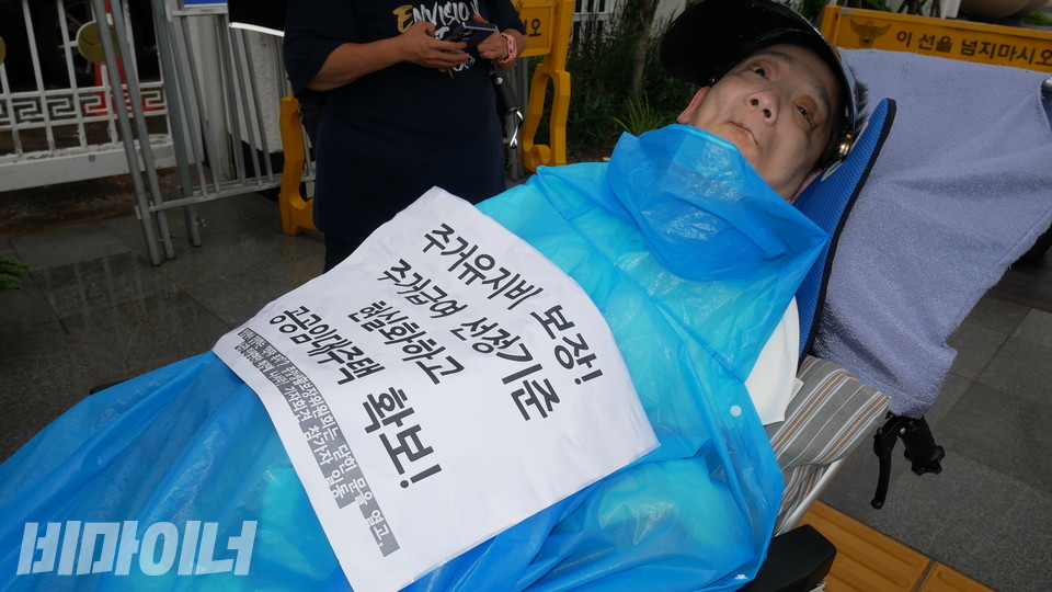 이영애 활동가가 “주거유지비 보장! 주거급여 선정기준 현실화하고 공공임대주택 확보!”라고 적힌 피켓을 몸에 붙였다. 사진 하민지