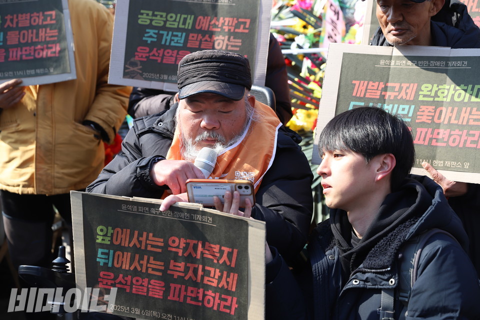 김명학 노들장애인야학 교장이 핸드폰 화면을 보며 발언하고 있다. 사진 김소영