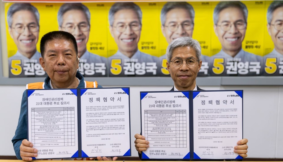 권달주 전국장애인차별철폐연대 상임공동대표와 권영국 민주노동당 후보가 정책협약서를 들어 보이며 기념사진을 찍고 있다. 사진 2025대선장애인차별철폐연대 제공