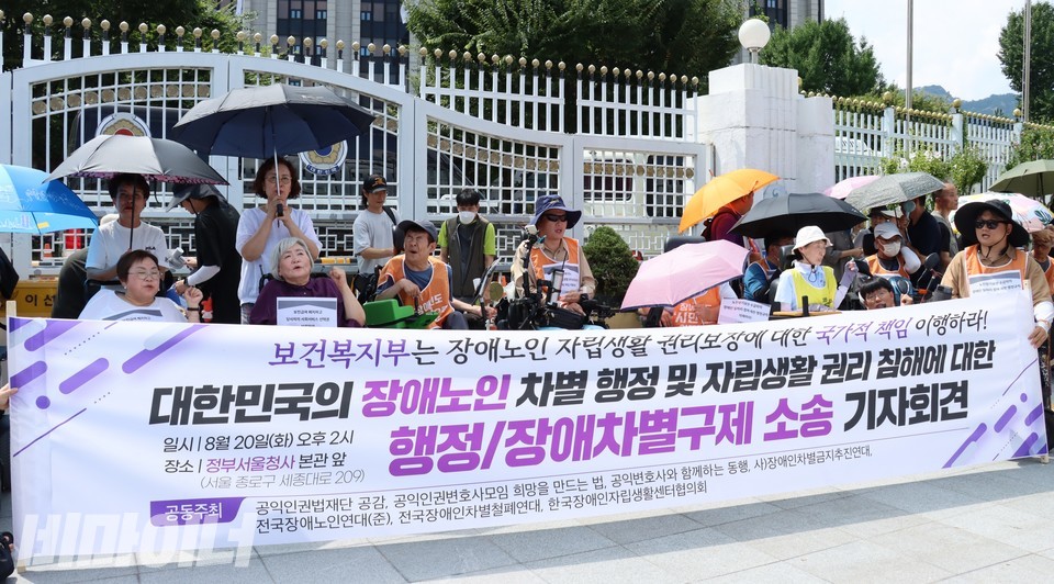 지난해 8월 20일, 정부서울청사 앞에서 열린 기자회견 현장. 현수막에 “보건복지부는 장애노인 자립생활 권리보장에 대한 국가적 책임 이행하라! 대한민국의 장애노인 차별 행정 및 자립생활 권리 침해에 대한 행정/장애차별구제 소송 기자회견”이라 적혀 있다. 사진 하민지
