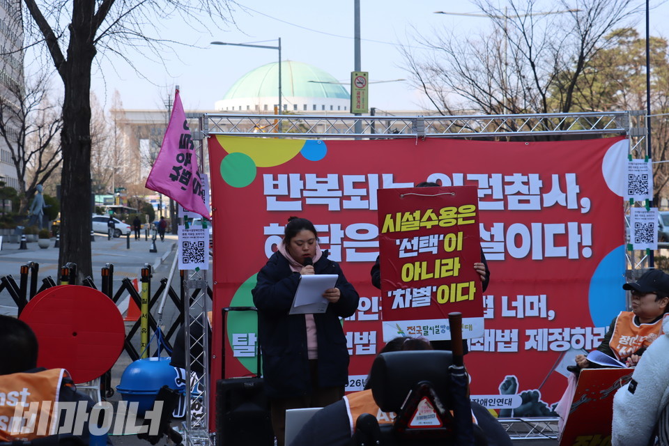 결의대회에 모인 전국탈시설장애인연대 회원들. 현수막 뒤에는 국회가 보인다. 사진 이재민