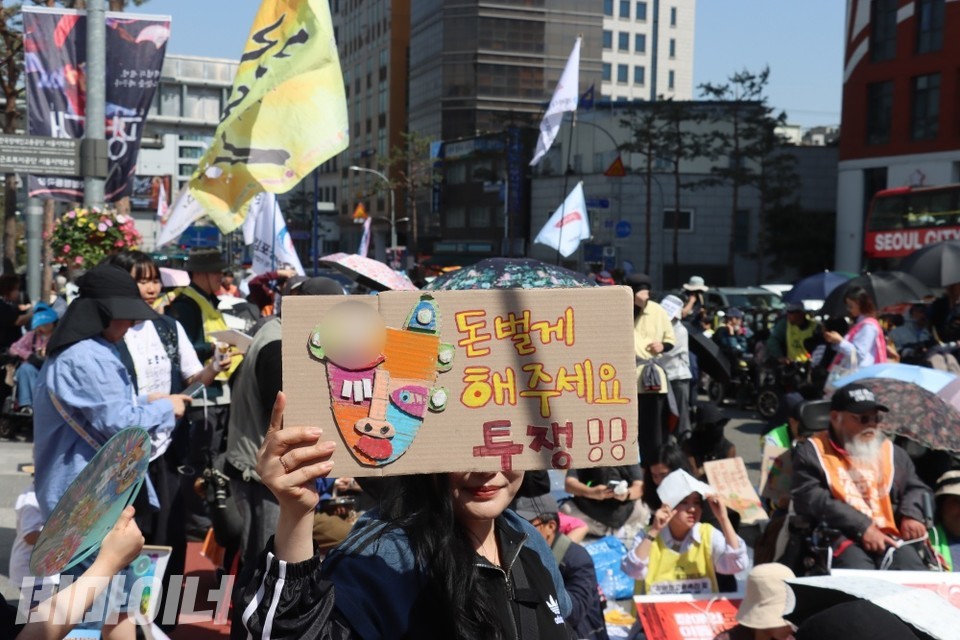 결의대회 참가자가 "돈 벌게 해주세요, 투쟁!"이라고 적힌 피켓을 들고 있다. 사진 이재민
